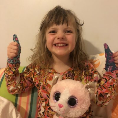 Little girl waring Thumbsie thumb guards