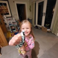Little girl happily wearing a penguin thumb guard