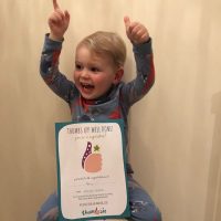 Little boy with his certificate for stopping thumb sucking with Thumbsie