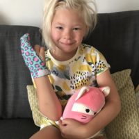 Little girl wearing a Thumbsie finger guard