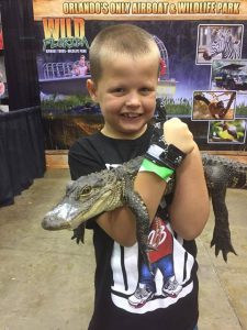 Boy with Aligator wearing g thumb guard