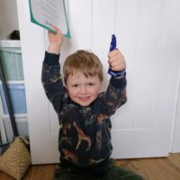 Little boy holding his success certificate after stopping thumb sucking