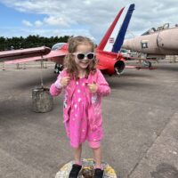 Little girl wearing her thumb gloves