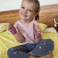 child wearing Thumbsie thumb sucking glove