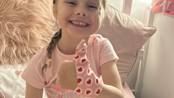 Little girl wearing a Thumbsie Thumb Glove